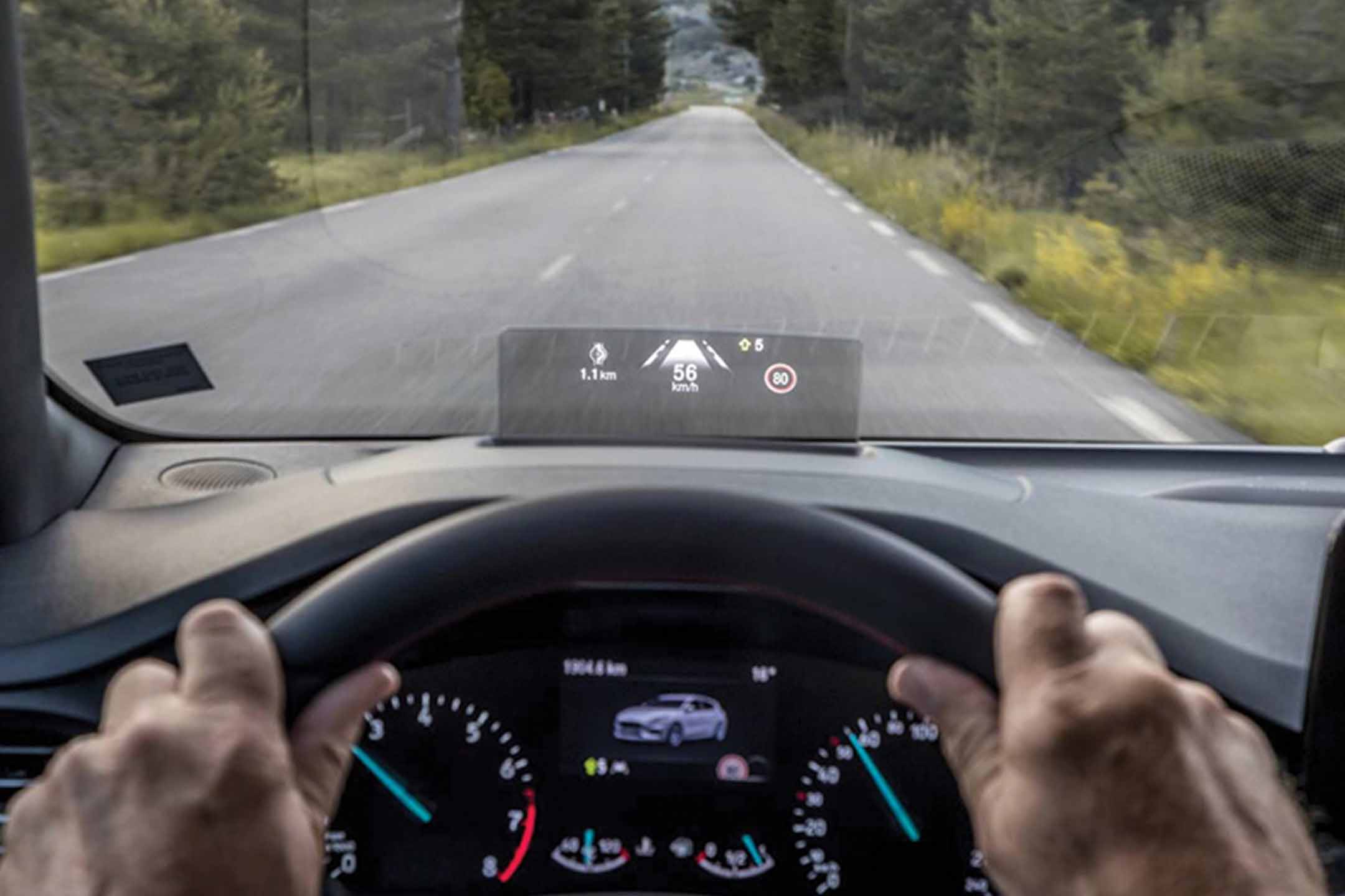 Driver viewing heads up display on a windshield